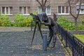 Bronze sculpture of a photographer with a vintage camera in the park