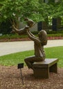 Bronze sculpture of woman holding up a happy child by Gary Price at the Dallas Arboretum and Botanical Garden