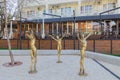 Bronze sculptures of three dancing girls.