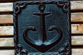 bronze sign as anchors on a wooden bench.