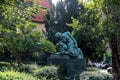 Bronze Statue Amidst Lush Greenery in a Prague Garden