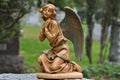 Bronze Statue of an Angel Kneeling and Praying in a Cemetery Royalty Free Stock Photo