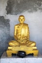 Bronze statue of Bhuddist monk with rough background Royalty Free Stock Photo