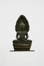 Bronze statue of a buddha kneeling in a meditative pose against a white background Royalty Free Stock Photo