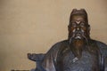 Bronze statue of Chinese man with hat and beard