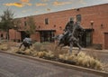 Bronze statue of a cowboy on horseback roping a steer on display at the Fort Worth Stockyards in Texas. Royalty Free Stock Photo