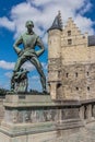 Bronze statue of De Lange Wapper and Het Steen, historic castle, Antwerp, Belgium