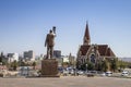 The bronze statue of Dr. Sam Nujoma and Christuskirche in Windhoek, Namibia Royalty Free Stock Photo