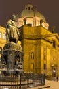 Bronze statue of the eleventh Czech King and Roman Emperor Charles IV. in night snowy Prague near Charles Bridg