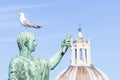 Statue of emperor Caesar Nervae August with gull on the head. Man taking selfie. Humor concept Royalty Free Stock Photo