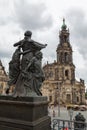 A bronze statue and the cathedral (Hofkirche) of Dresden, Saxony, Germany