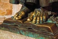 Bronze statue of feet over open book at Caceres