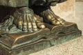 Bronze statue of feet over open book at Caceres