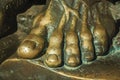 Bronze statue of foot over an open book at Caceres