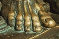 Bronze statue of foot over an open book at Caceres