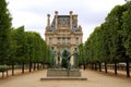 Bronze statue in fromn of Louvre museum building Royalty Free Stock Photo