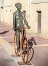 Bronze statue of girl on bicycle