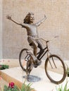 Bronze statue, girl on bicycle