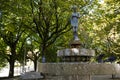 Bronze statue of a girl in the middle of a city garden. Fountain with pigeons taking a bath on a hot day. Alameda gardens Royalty Free Stock Photo