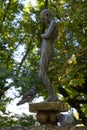 Bronze statue of a girl in the middle of a city garden. Fountain with pigeons taking a bath on a hot day. Alameda gardens Royalty Free Stock Photo