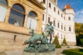 Bronze statue of a hunter with two dogs near Historic Medieval Konopiste castle, terrace of romantic gothic baroque Chateau in