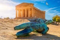 Bronze statue of Icarus in front of the Temple of Concordia at the Valley of the Temples. Temple of Concordia and the statue of Royalty Free Stock Photo