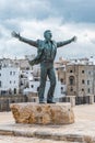 Bronze statue of the Italian singer Domenico Modugno in Polignano a Mare, Bari, Italy