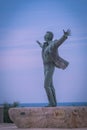 Bronze statue of the italian singer Domenico Modugno on the promenade of Polignano a Mare, Puglia, Italy