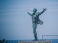 Bronze statue of the italian singer Domenico Modugno on the promenade of Polignano a Mare, Puglia, Italy