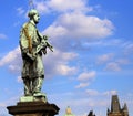 Bronze statue of John Nepomucene with halo and crucifix Royalty Free Stock Photo