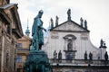 Bronze statue of king Charles IV and Church of the Blessed Savior on Crusader Square near Charles Bridge in winter, Old Town of Royalty Free Stock Photo