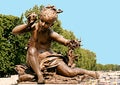 Bronze statue of a little girl hearing the sound of a conch and