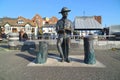 Bronze statue sitting on tour boat quay