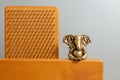 Bronze statue of Lord Ganesha. Brown Sadhu wooden boards with nails for yoga practices on the grey background