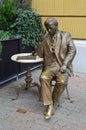 Bronze statue of man drinking coffee at cafe table, Pecs Hungary