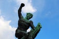 Bronze statue of a man fighting against an animal