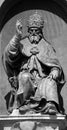 Bronze statue of Pope Gregory XIII, sitting and blessing.