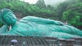 Bronze statue of a reclining Buddha in Sasaguri, Juk, said to be the largest bronze statue in the world, on a rainy and cloudy day