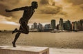 Bronze statue in Stanley Park of running man Harry Jerome in the skyline of Vancouver city in the background Royalty Free Stock Photo