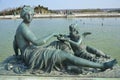 Bronze statue of three cherubs on the edge of a basin of the Bassin du Midi in the gardens of Versailles, in front of the west Royalty Free Stock Photo