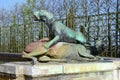 Bronze statue of three cherubs on the edge of a basin of the Bassin du Midi in the gardens of Versailles, in front of the west Royalty Free Stock Photo