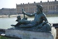 Bronze statue of three cherubs on the edge of a basin of the Bassin du Midi in the gardens of Versailles, in front of the west Royalty Free Stock Photo