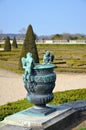 Bronze statue of three cherubs on the edge of a basin of the Bassin du Midi in the gardens of Versailles, in front of the west Royalty Free Stock Photo