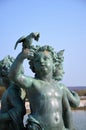 Bronze statue of three cherubs on the edge of a basin of the Bassin du Midi in the gardens of Versailles, in front of the west Royalty Free Stock Photo