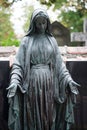 Bronze statue of the virgin mary on tomb in a cemetery Royalty Free Stock Photo