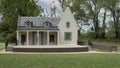 Bronze statue of Washington Irving and facade of his New York home in Washington Irving Memorial Park in Bixby, Oklahoma.