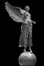 Bronze statue of a Winged Victory. Frontal view of a Statue of the goddess Nike, isolated on black background by Royalty Free Stock Photo