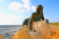 Bronze statue of woman called `Sol Alter` on a stone, Paphos, Cy