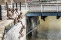 Bronze statues of children jumping into the river in Singapore.