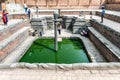 Bronze statues of the mythical Shesh nag guard in a temple pond in Bhaktapur, Kathmandu